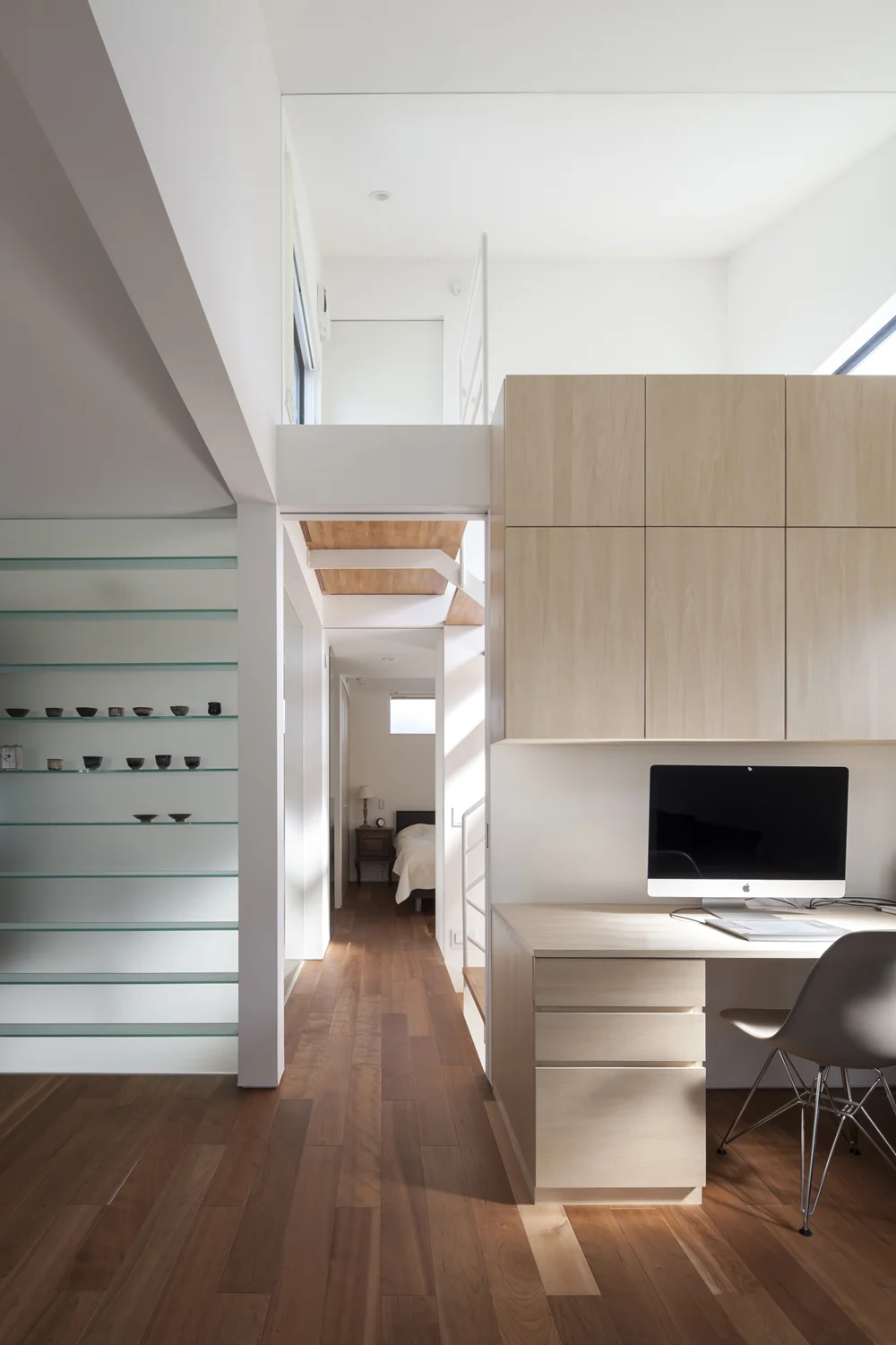 The white door seen above serves as the entrance to the loft.