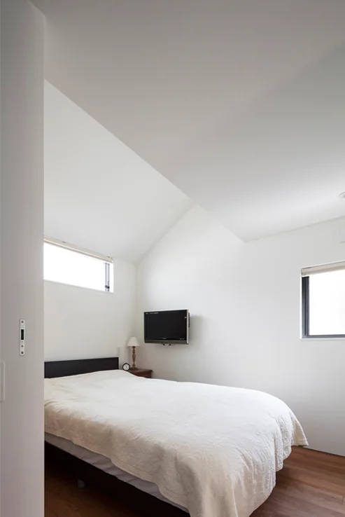 The bedroom features a section with an elevated ceiling height.