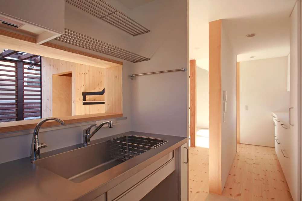 The kitchen is enclosed with openings just sufficient for the wife to observe her family while focusing on cooking