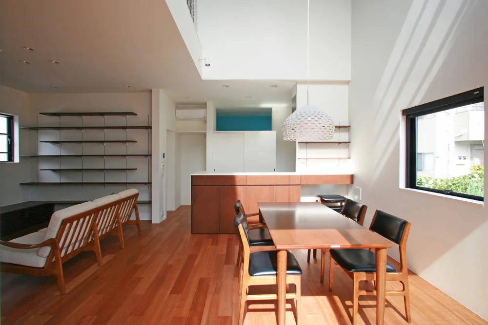 The kitchen’s waist-height wall incorporates shallow-depth storage, ideal for organizing small items, dishware, and decorative shelving.