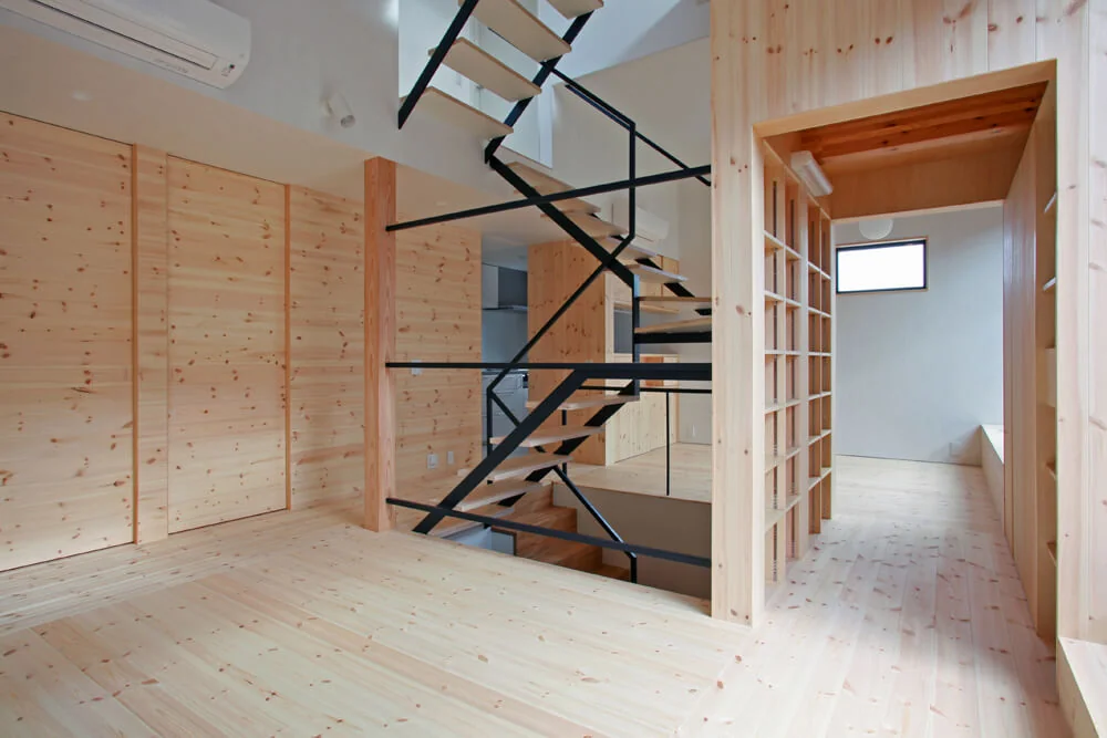 Passing through the storage box corridor leads to the dining area, where floors and walls are clad with pine boards