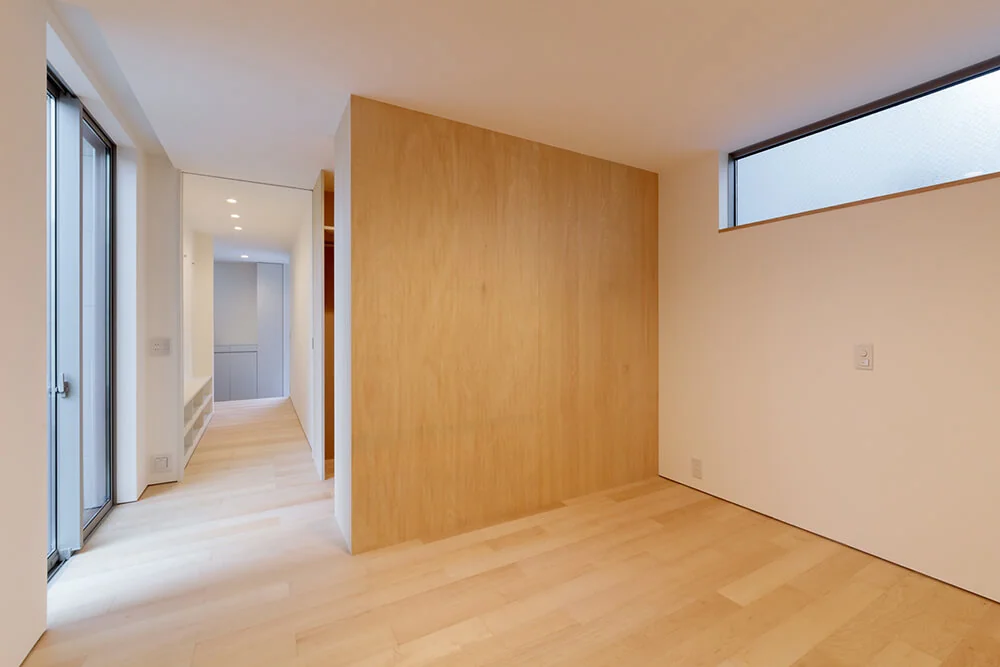 The master bedroom includes a walk-in closet and opens onto a drying terrace through large sliding doors.