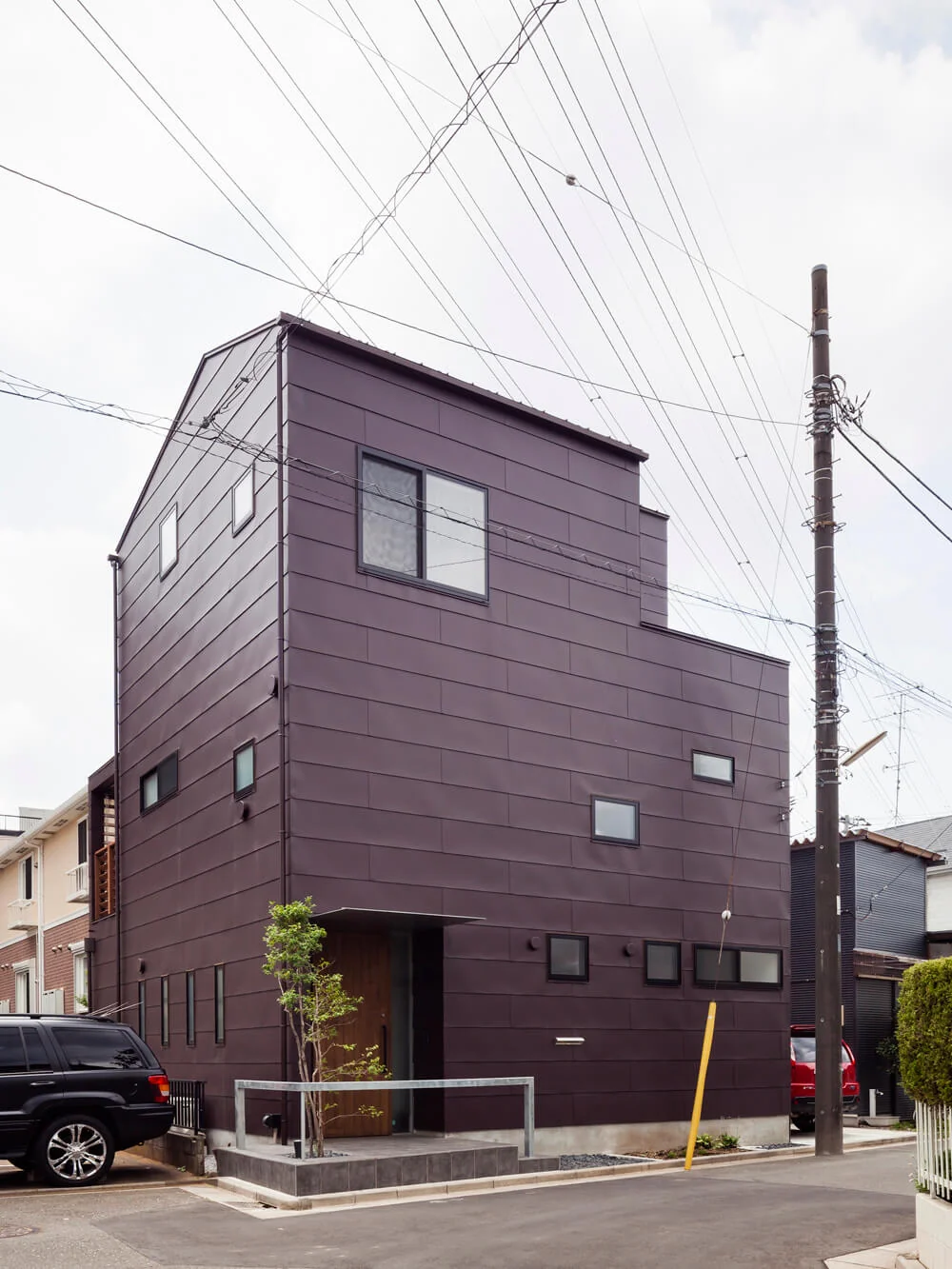 Exterior clad with standing seam Galvalume steel panels and a symbolic Kurosoyogo tree