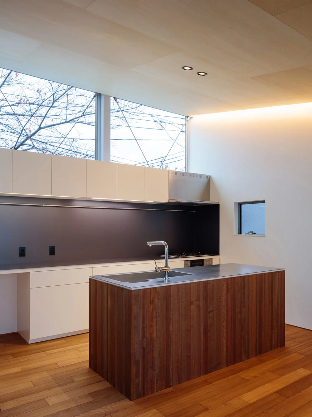 An island kitchen crafted to the husband’s specifications, designed for shared family use and interaction.