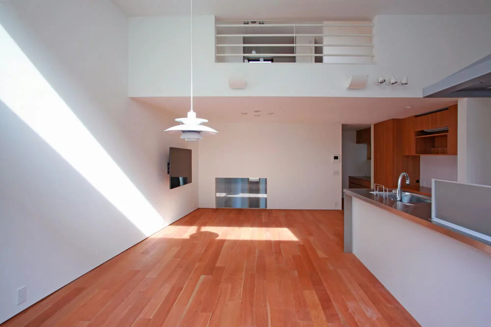 The dining kitchen with its lofty ceiling is adorned with a pendant light, fulfilling the homeowners' aspiration.