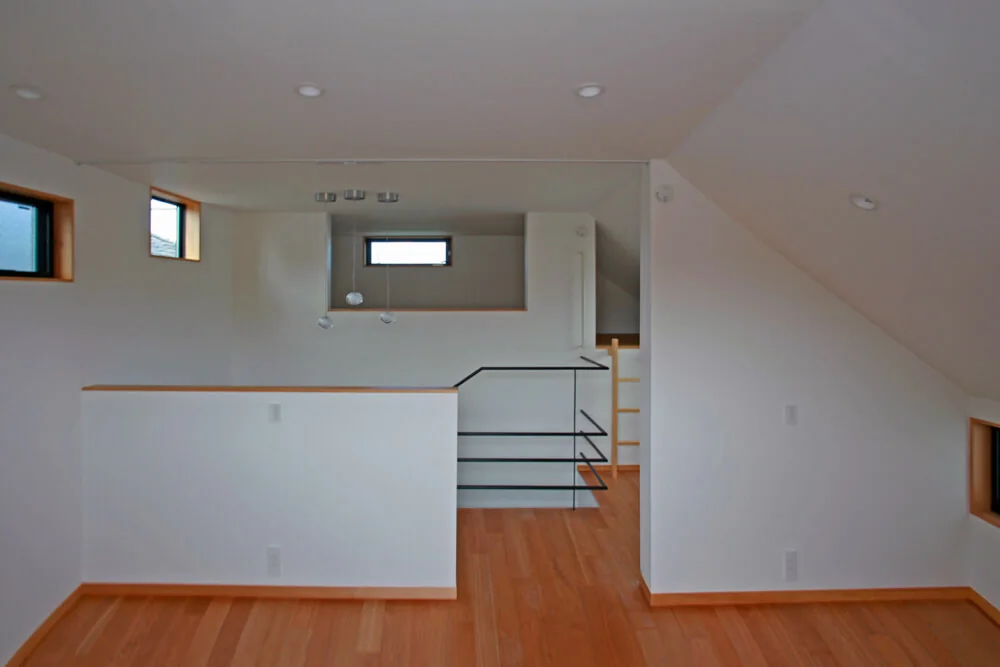 At the top of the skip floor sequence is a secluded loft accessed via a wooden ladder, serving as a private retreat for the husband.