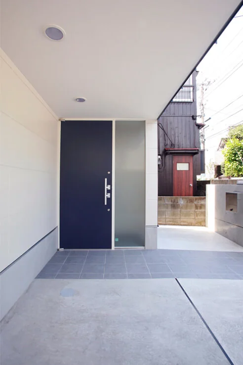 The entrance porch features a 1.8-meter cantilevered structure to secure parking space, with a bicycle storage area positioned at the rear right corner.