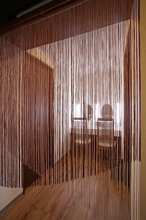 View of the powder room through a fringed curtain
