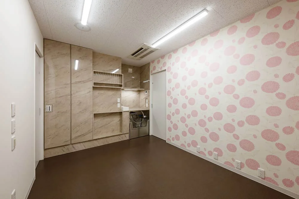 Examination Room 2’s custom millwork includes deep storage, instruction sheet shelving, a handwashing basin, and a foot-operated sink.