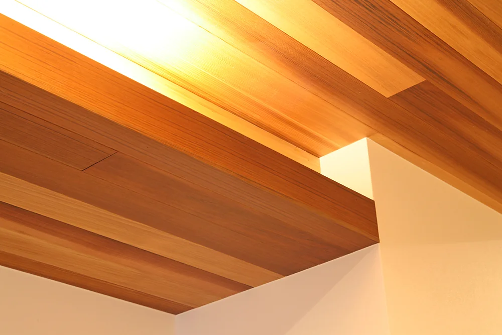 Cove lighting in the ceiling recess accentuates the red cedar paneled ceiling