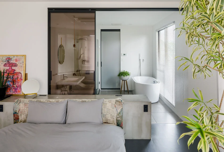 An integrated master bedroom and bathroom creating a seamless living environment