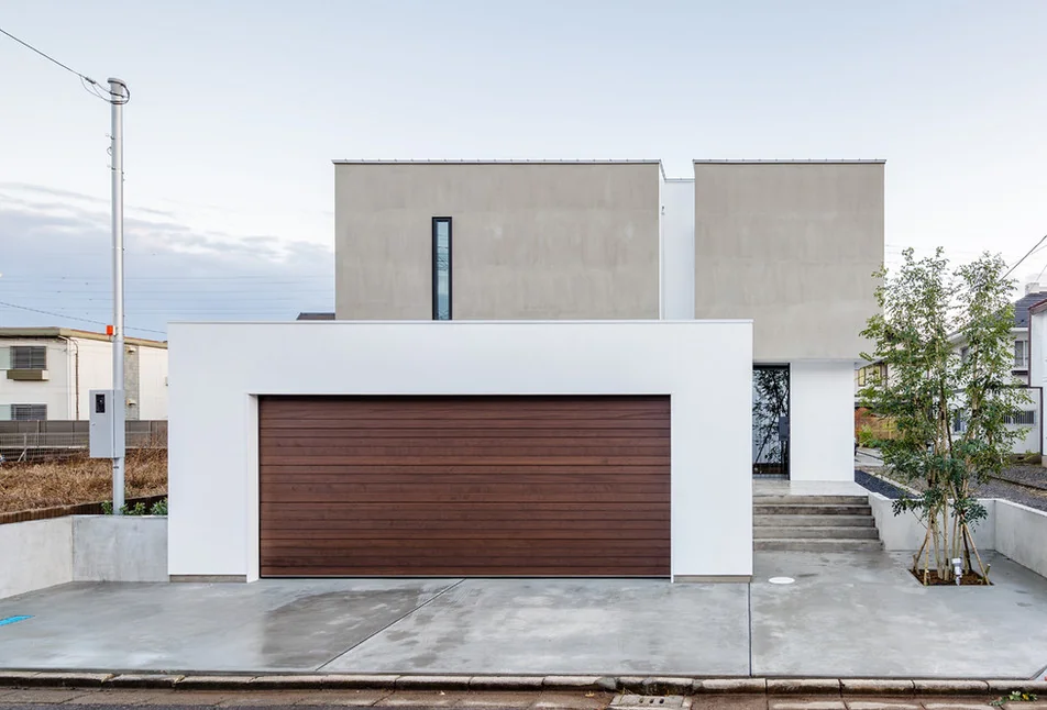 The wooden overslider garage door adds warmth to the exterior facade