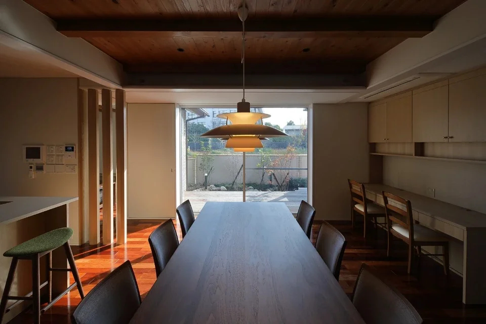 Facing south, the dining room is set slightly back behind the main garden and wooden deck to ensure privacy.