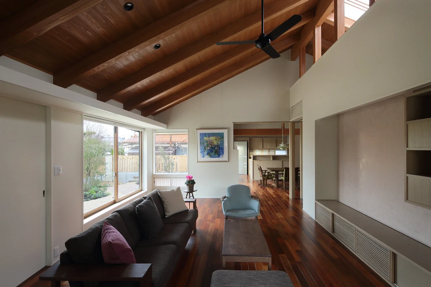 The living room connects to the dining room with a dogleg turn.