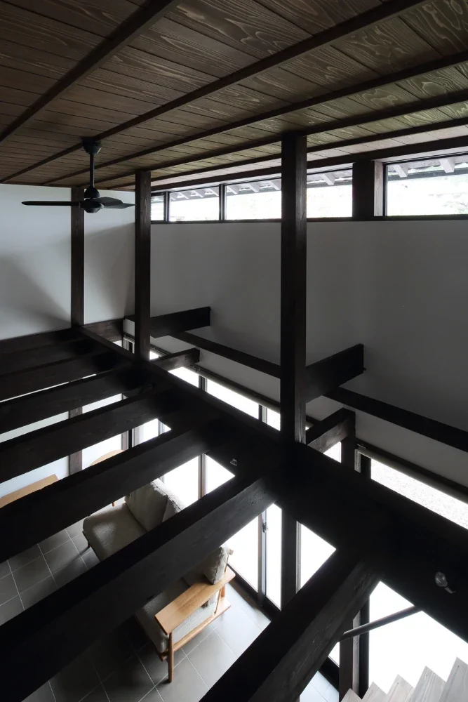 Light pours in through the high windows installed in the void.