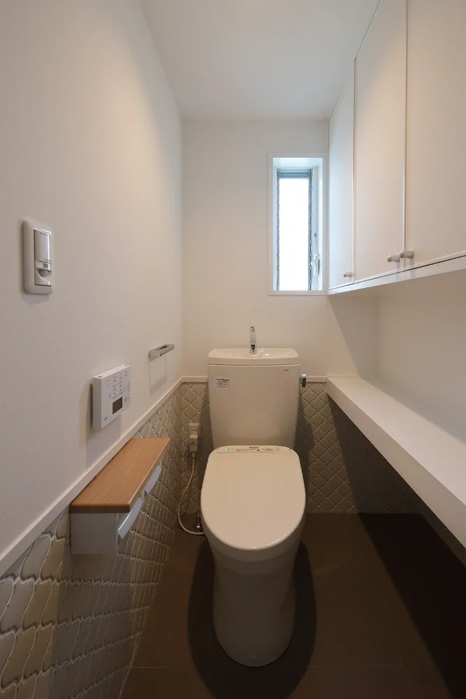 The floor and walls are tiled; the space beneath the shelving is for the cat litter box, and the entrance door also has a cat flap.