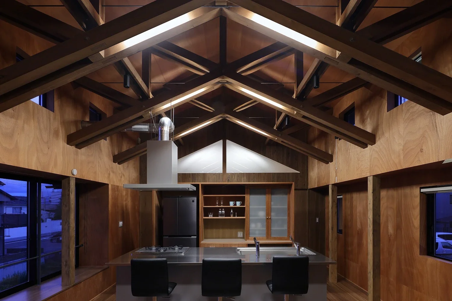 Light fixtures are integrated between the timbers that make up the roof.