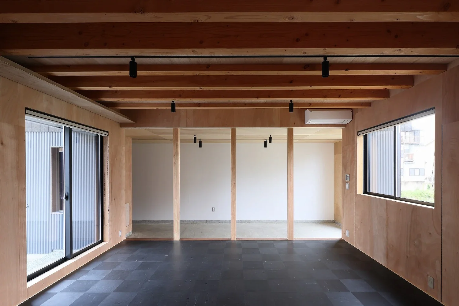 The area at the back, with its concrete slab left exposed as an earthen floor, is also divided by columns.