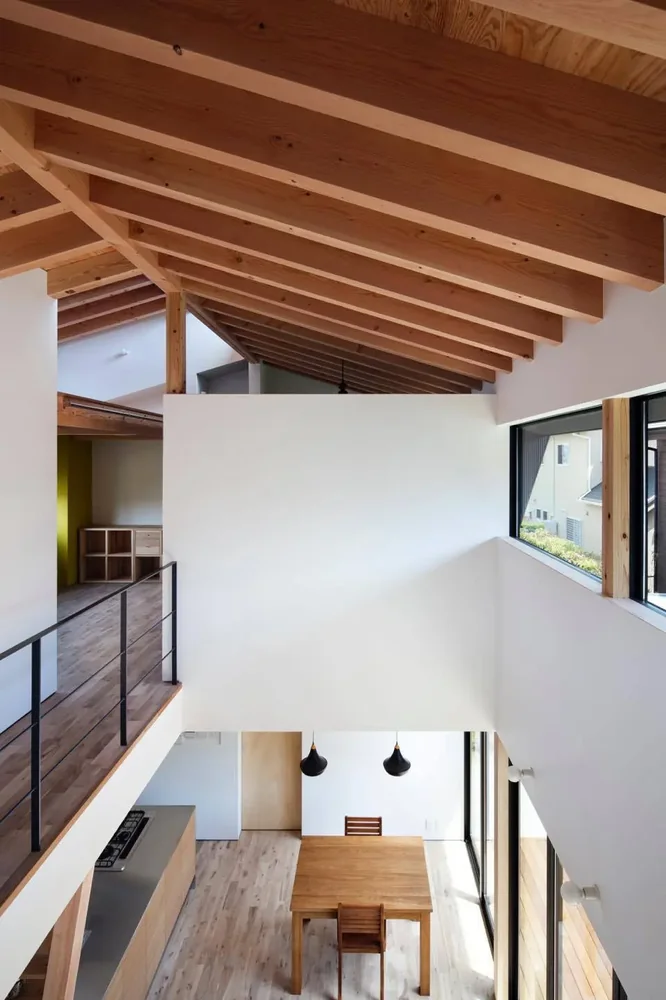 The gable roof structure is expressed architecturally, connecting the first and second floors around a central double-height space.
