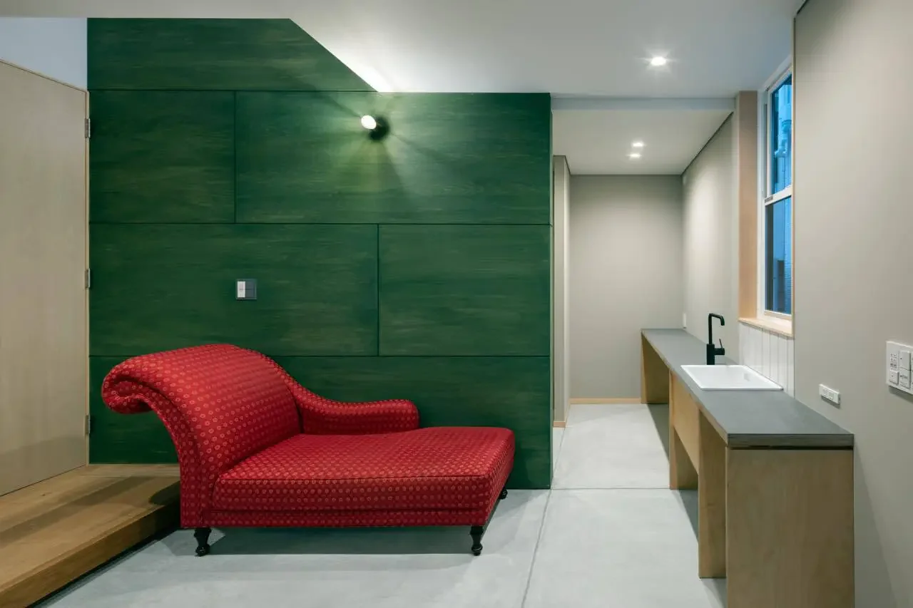 The entrance foyer is actively used with desks and sofas placed within.