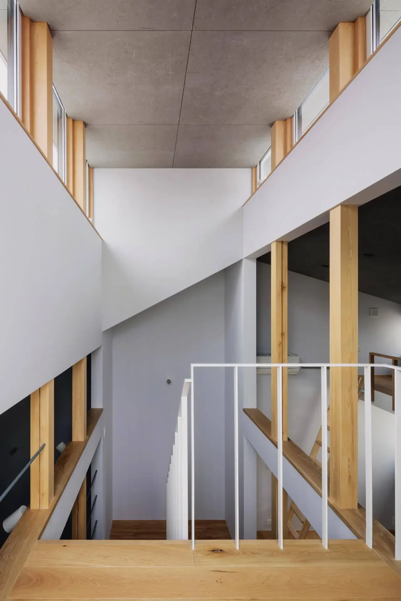 Light enters the interior through openings in the staircase.