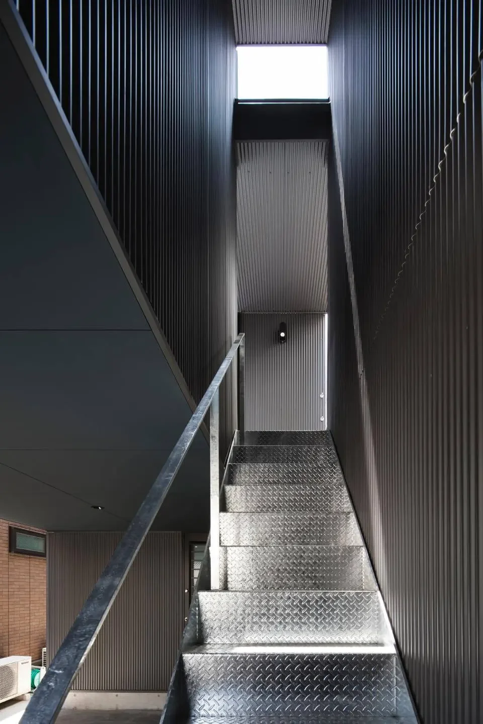 The sky is visible beyond the outdoor staircase