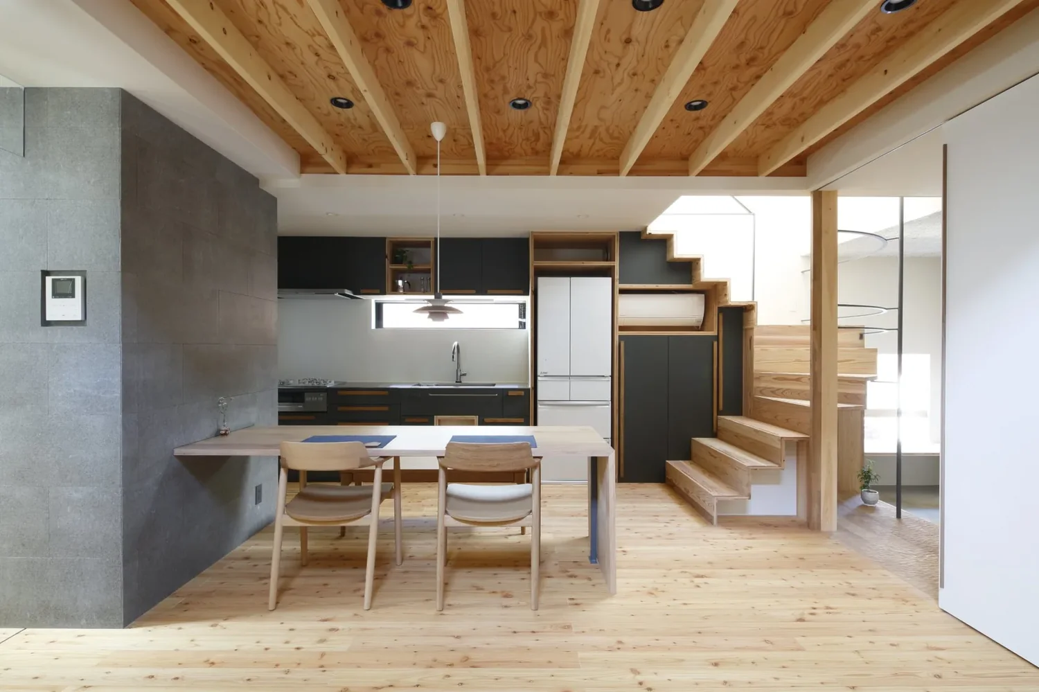 Kitchen seamlessly integrated with the staircase
