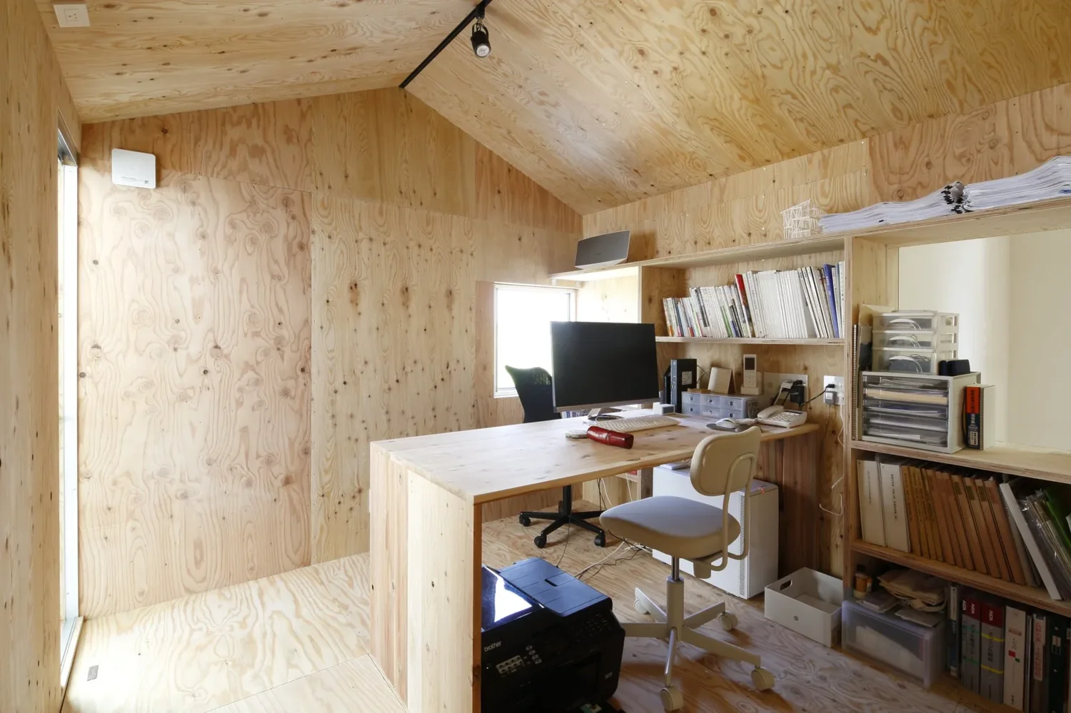 Work space featuring exposed plywood surfaces