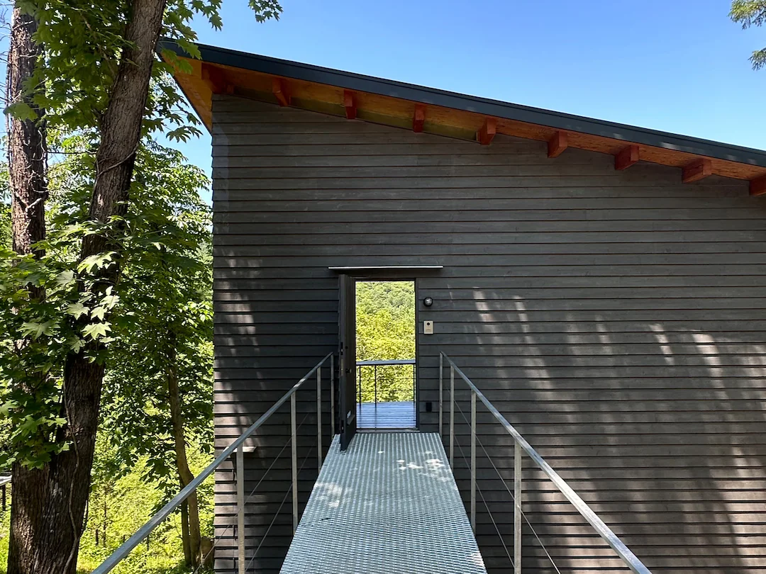 Approach-side exterior walls feature horizontal siding, delineating a clear boundary from everyday life