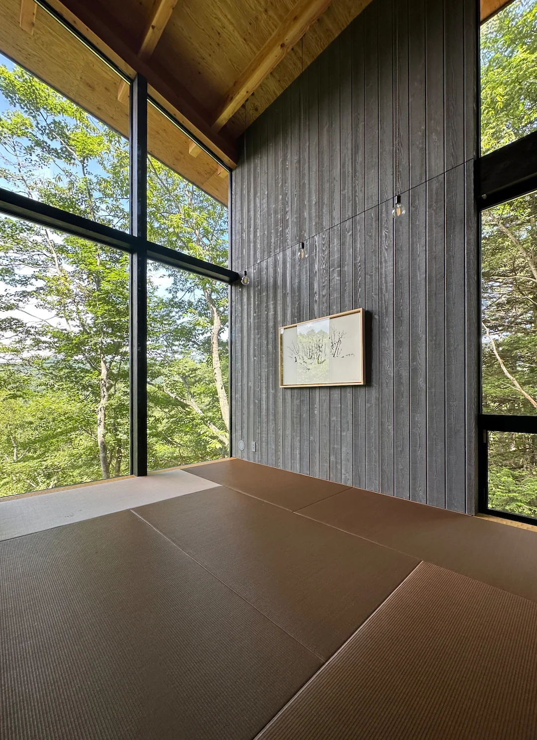 Structural walls serving as display panels are clad in wood boards, allowing flexible positioning according to artwork size and mood