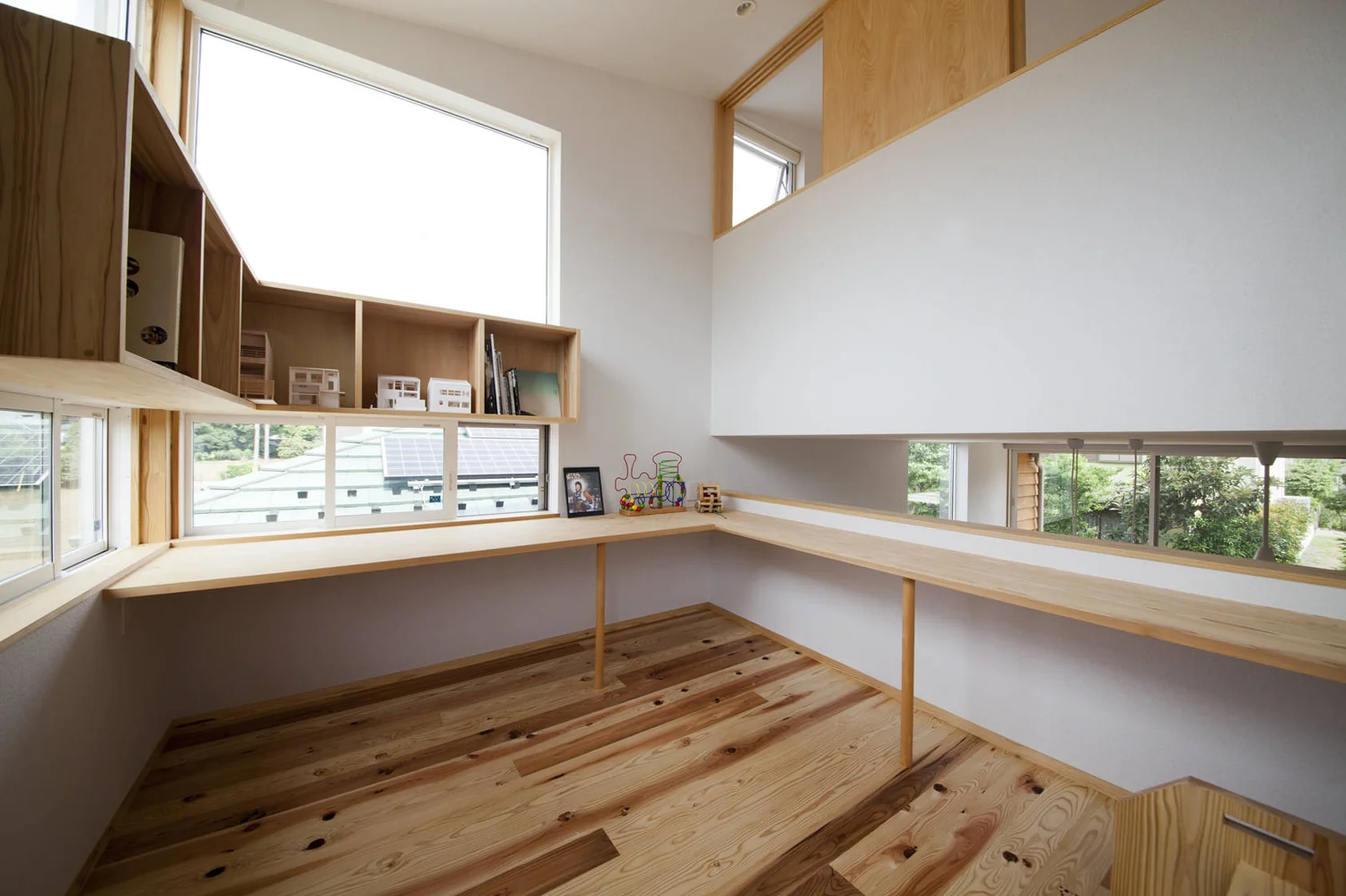 Expanded staircase landing creates an open workspace and loft