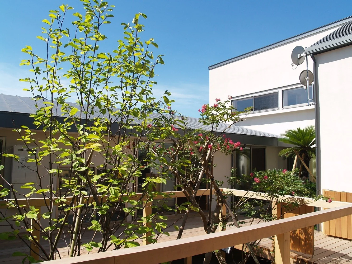 The two generations are connected by a wood deck centered around the courtyard