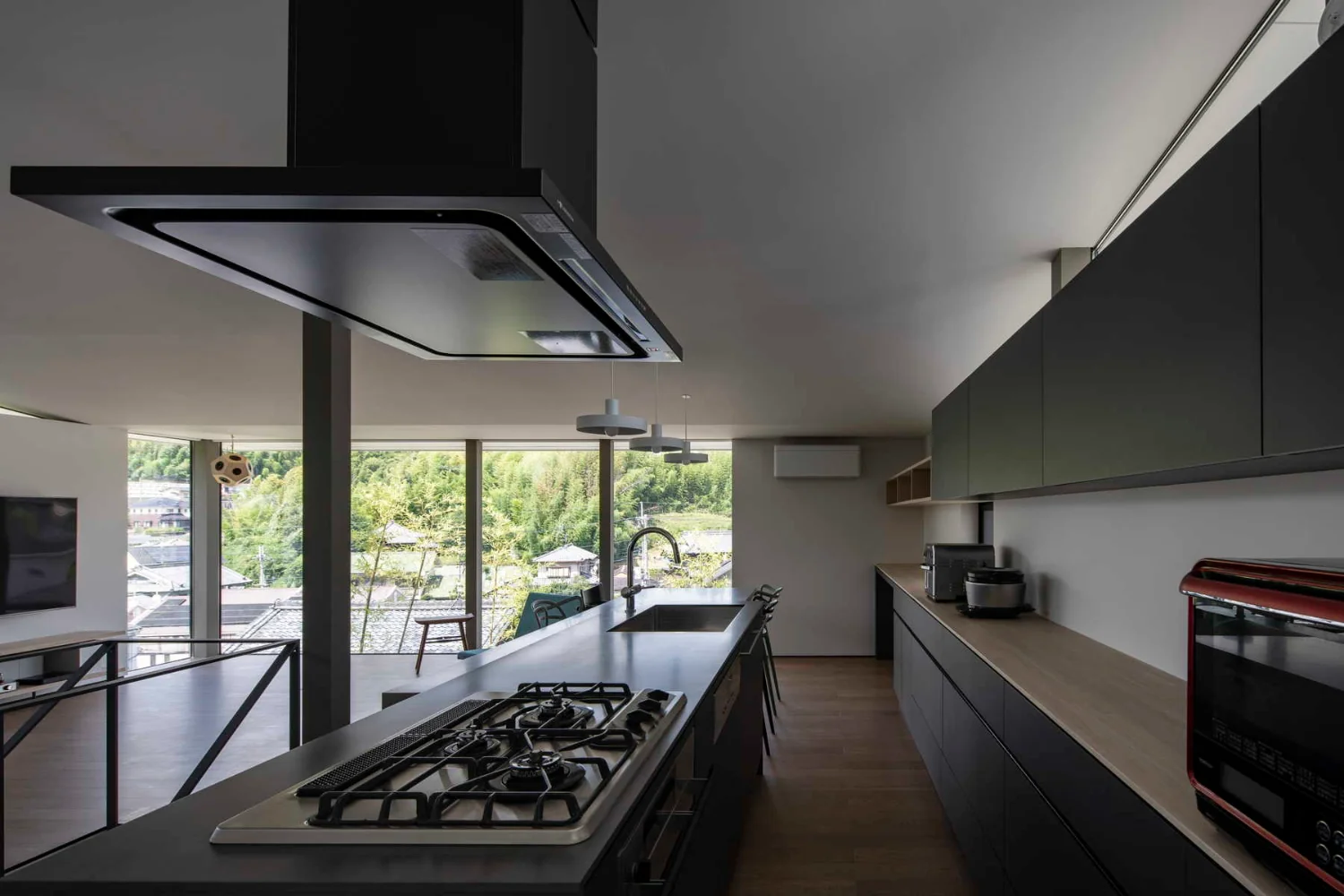 The kitchen occupies the best position for cooking while overlooking the entire living area and the views beyond the windows.