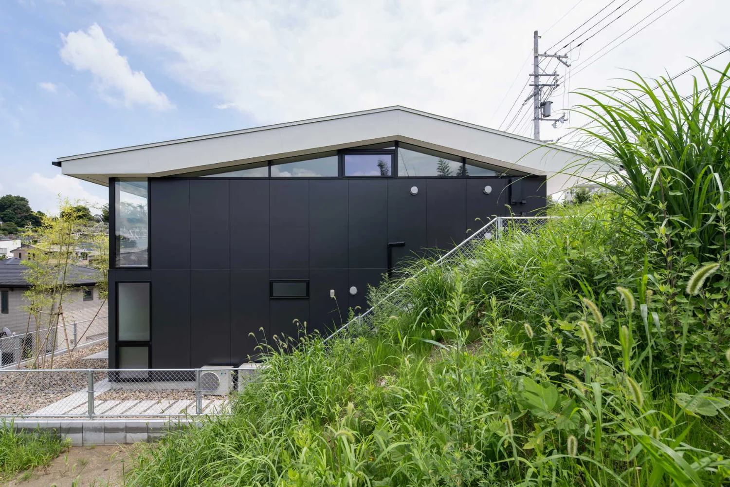 The reinforced-concrete frame is half-embedded into the hillside to form a high foundation, avoiding a mixed-construction approach.