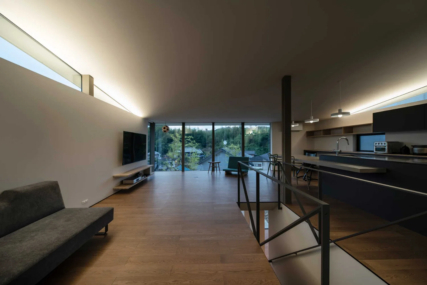 LDK at dusk. Indirect lighting concealed in the east and west slit windows provides overall illumination.