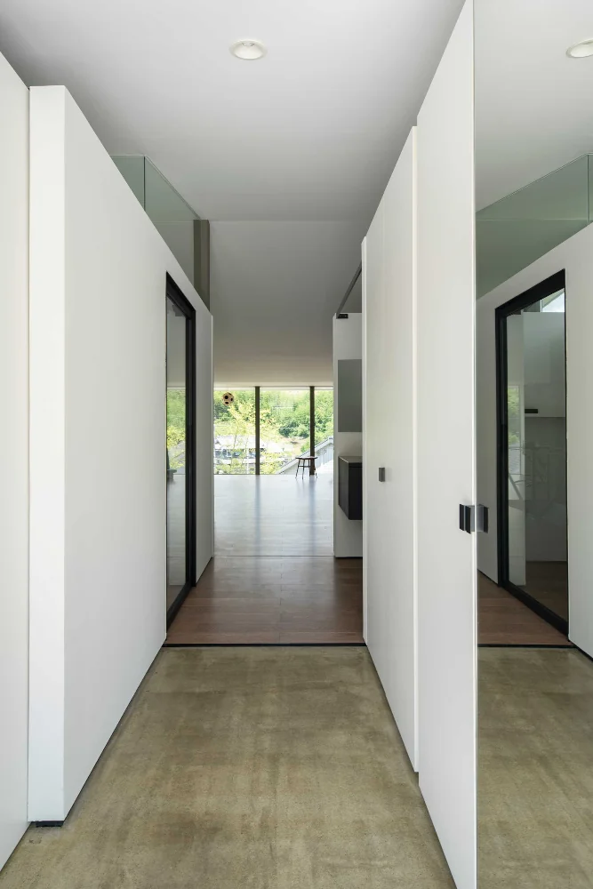 From the closed entrance to the open-plan living/dining/kitchen. There is virtually no step between the doma (earthen-floor entry) and the LDK.