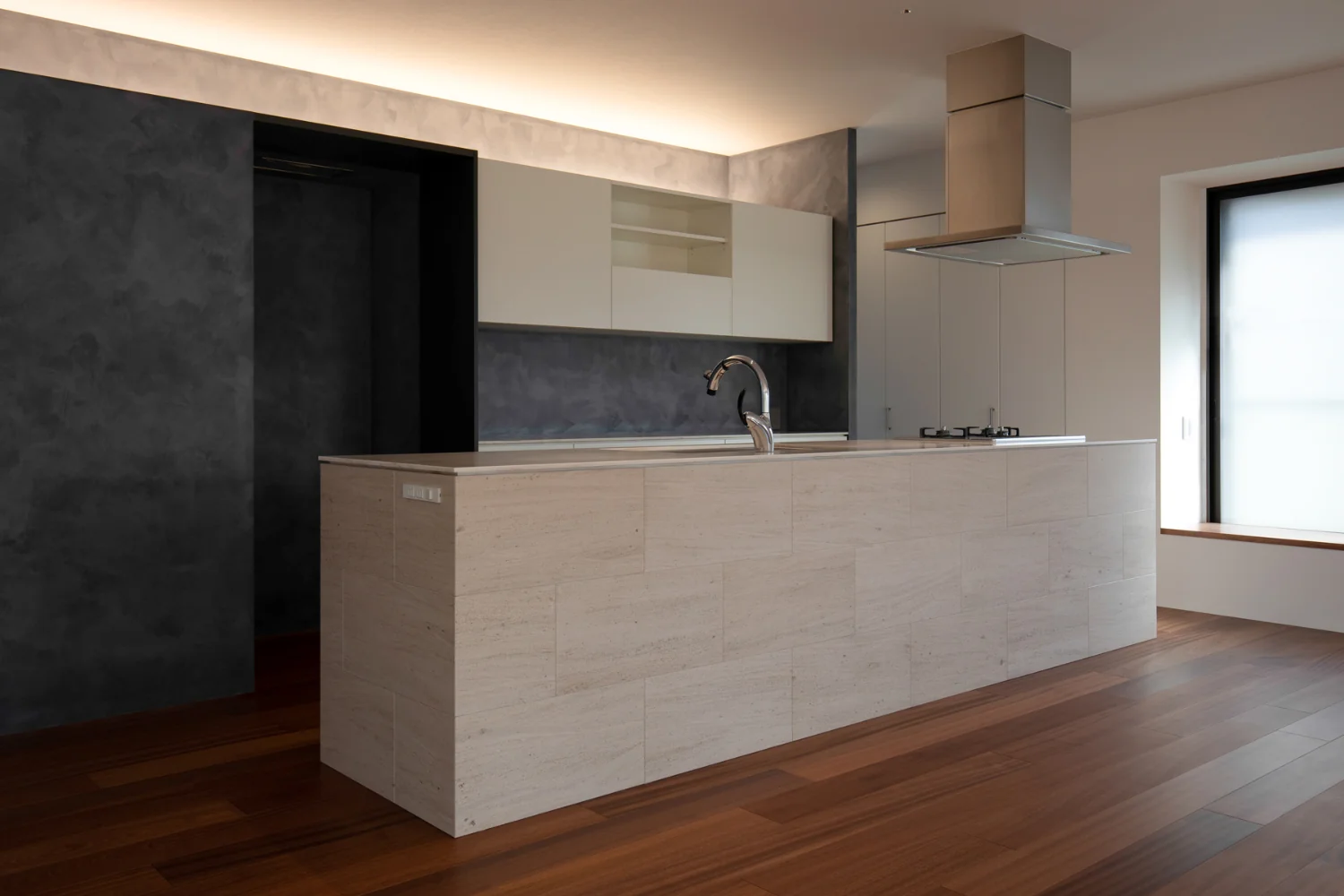 Large island kitchen, 3,600 mm in length. Side panels clad in limestone.