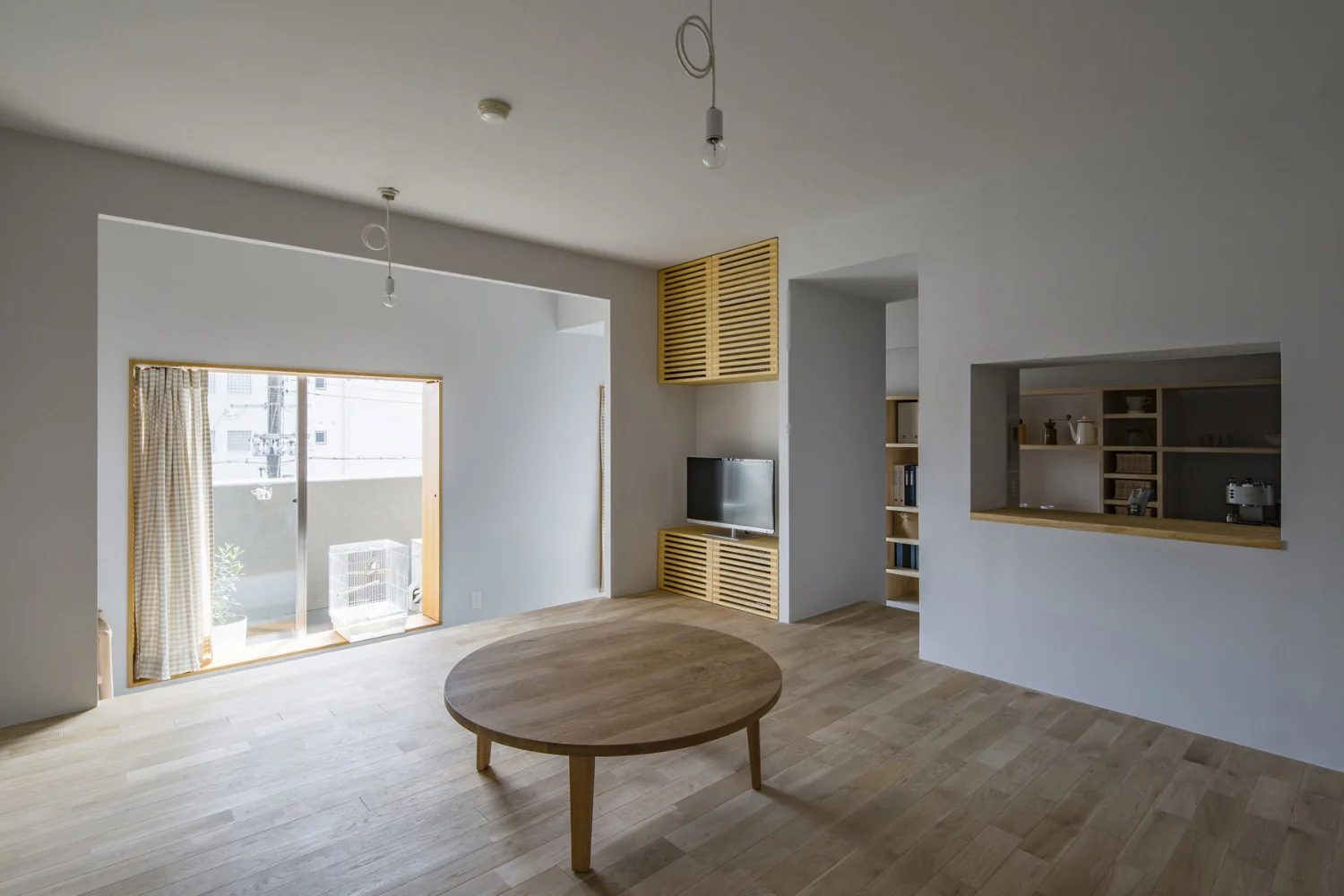 Walls and ceilings are pale gray. The oak (nara) flooring is left unfinished to preserve its tactile quality.