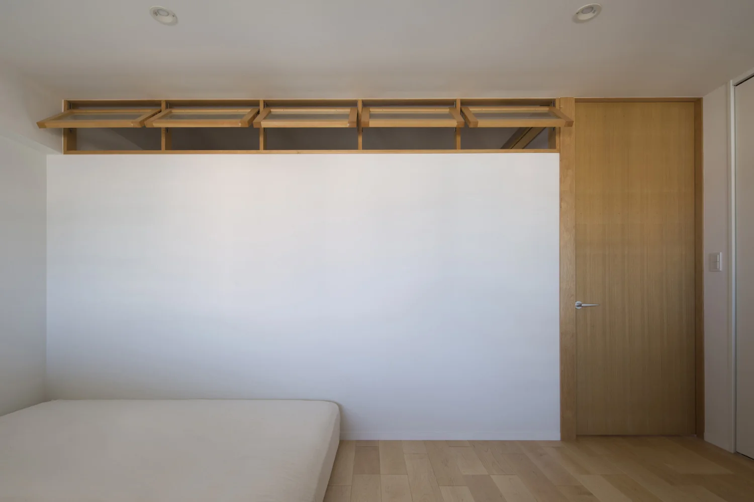 A large mattress spans the full width of the opening, enabling the family to sleep together freely.