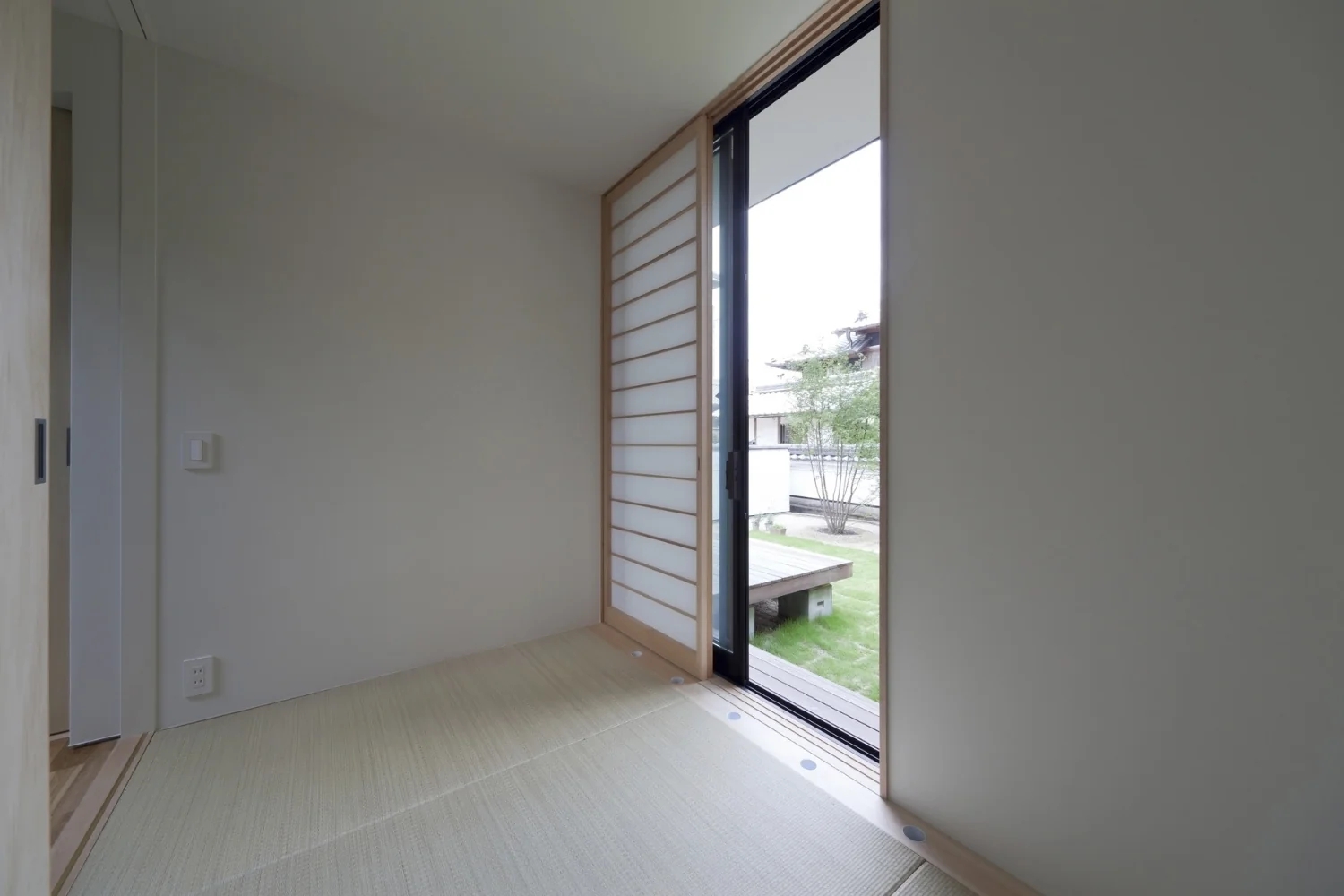 A small Japanese-style room used as an auxiliary space. The opening at the window serves as the vent for the thermal storage heating/cooling system.