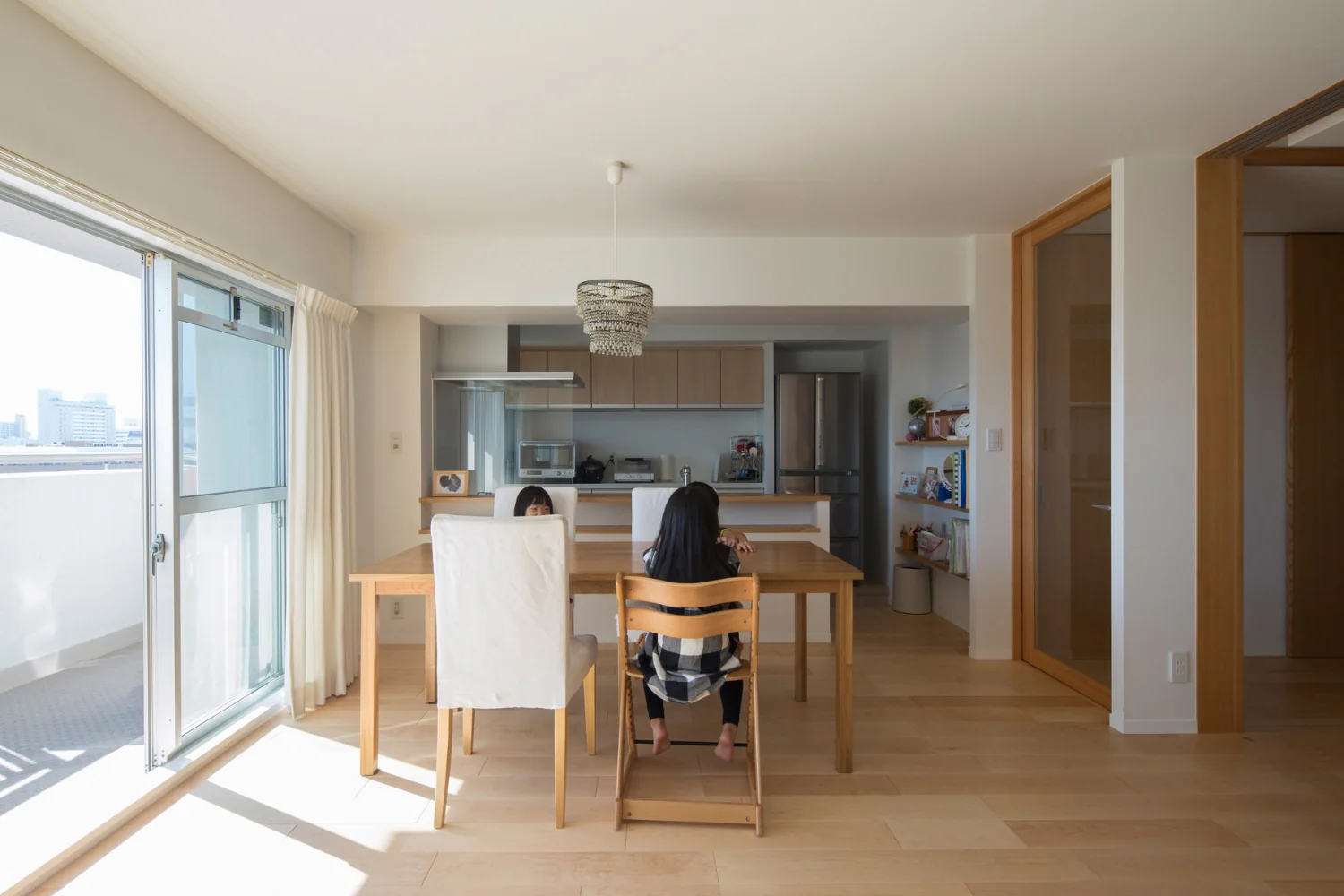 Kitchen with generous storage: built-in counter, adjustable shelving, and a cupboard.
