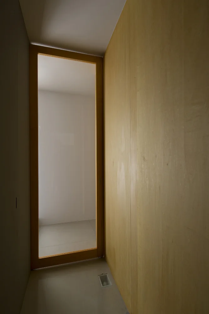 Footlights recessed into the floor. The glass sliding door is stored within the wall.