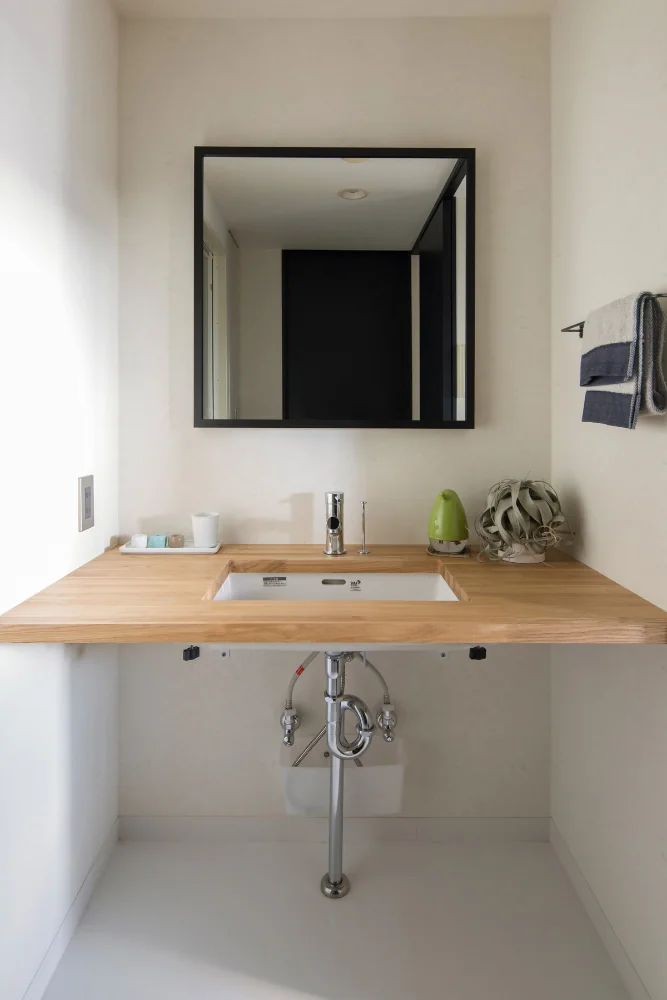 A simple washroom with a laminated ash timber counter.