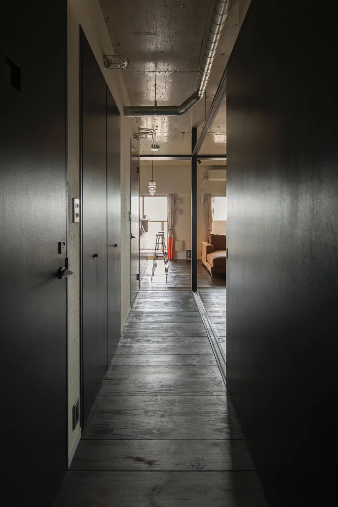 View from the corridor toward the living room. Ceiling boards were removed to expose the concrete. Ceiling height is 2.6 m.
