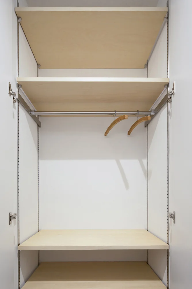 The closet incorporates adjustable shelving and movable hanging rails to enhance flexibility.