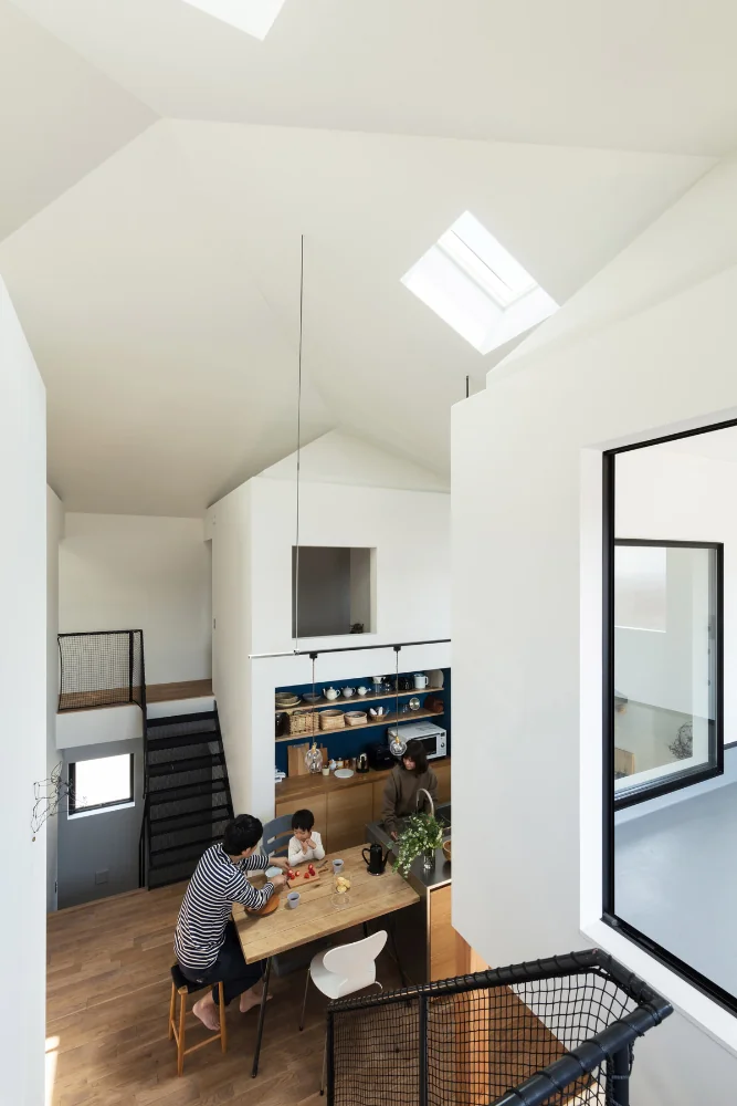 View toward the four‑corner space from the study. The staircase is constructed of expanded metal.