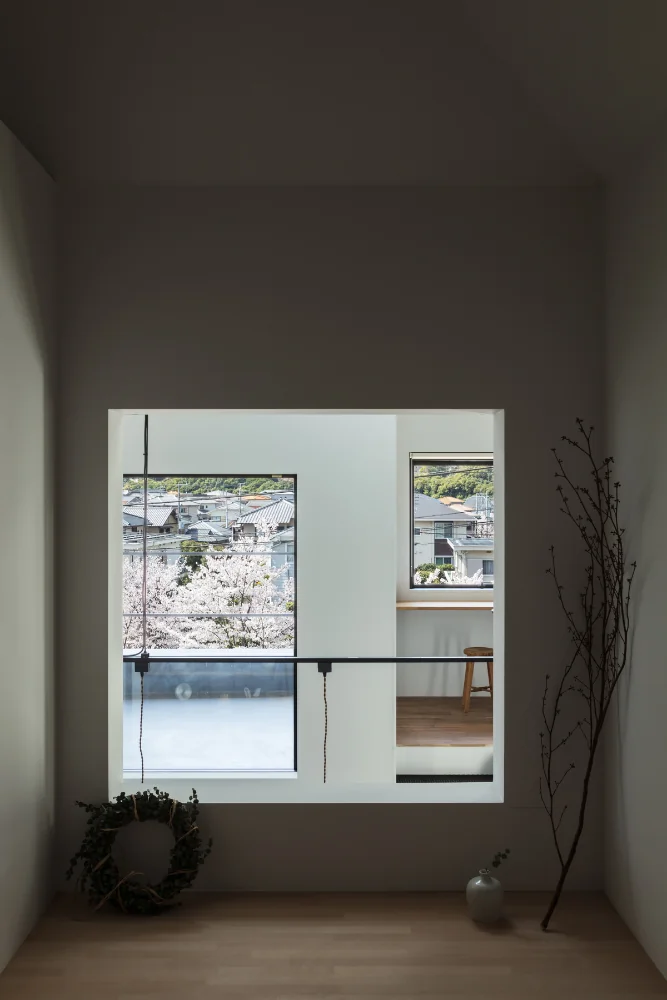 From the Japanese room's window one can see the main house, the terrace, and the avenue of cherry trees.
