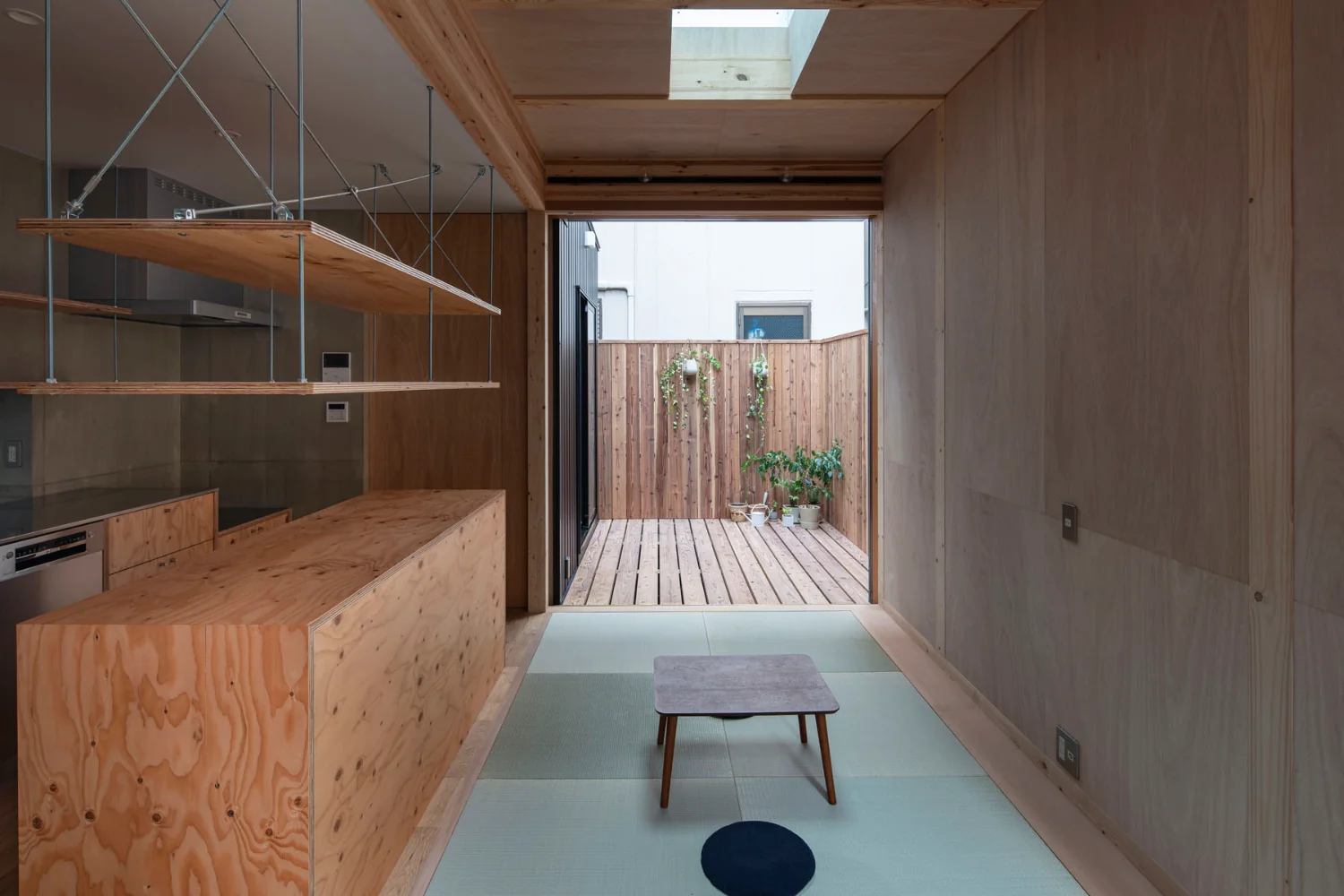 The compact living room has an increased ceiling height and a skylight to prevent a cramped feeling.