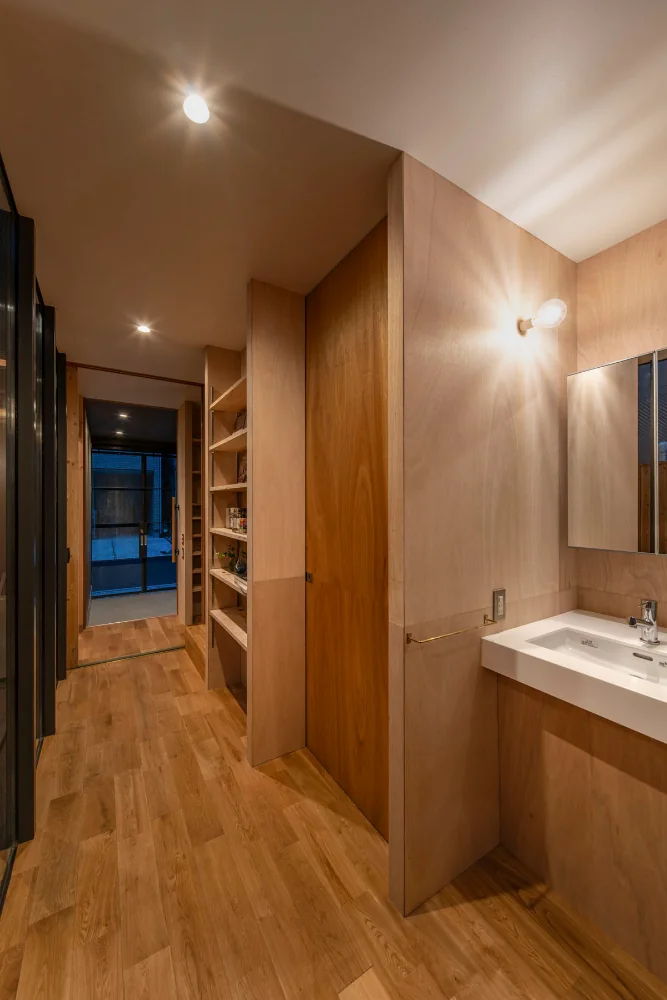 The washbasin and toilet are compactly consolidated under the stairs.