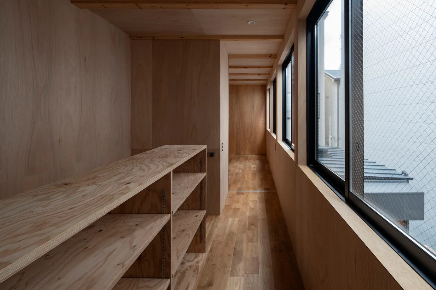 The second floor accommodates the son's room, a guest room, and storage within a minimal volume.